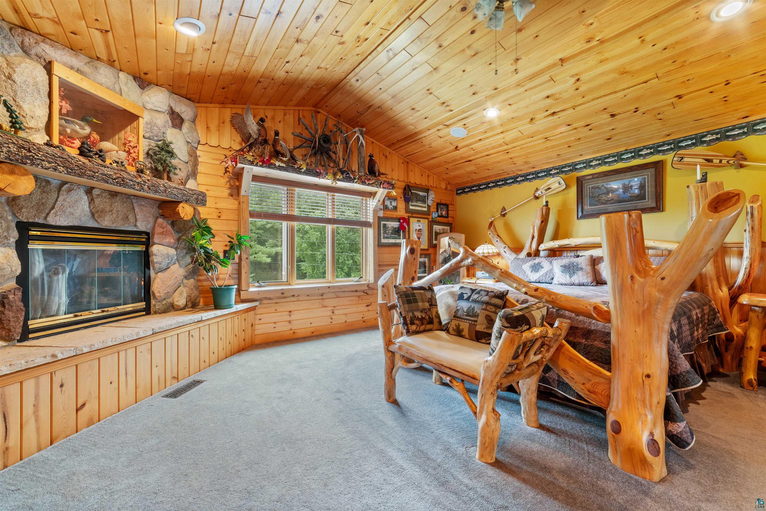 11911 East Rowe Road Lake Nebagamon, WI 54849 - Photo 39 of 61 Stone-faced fireplace with a hearth and wood mantel