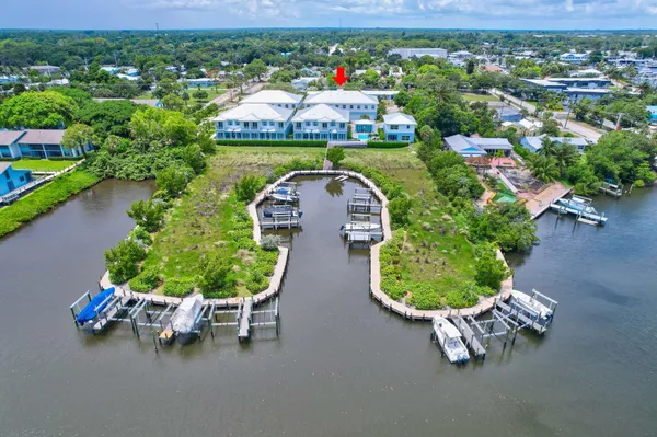 an aerial view of a house with a garden and lake view