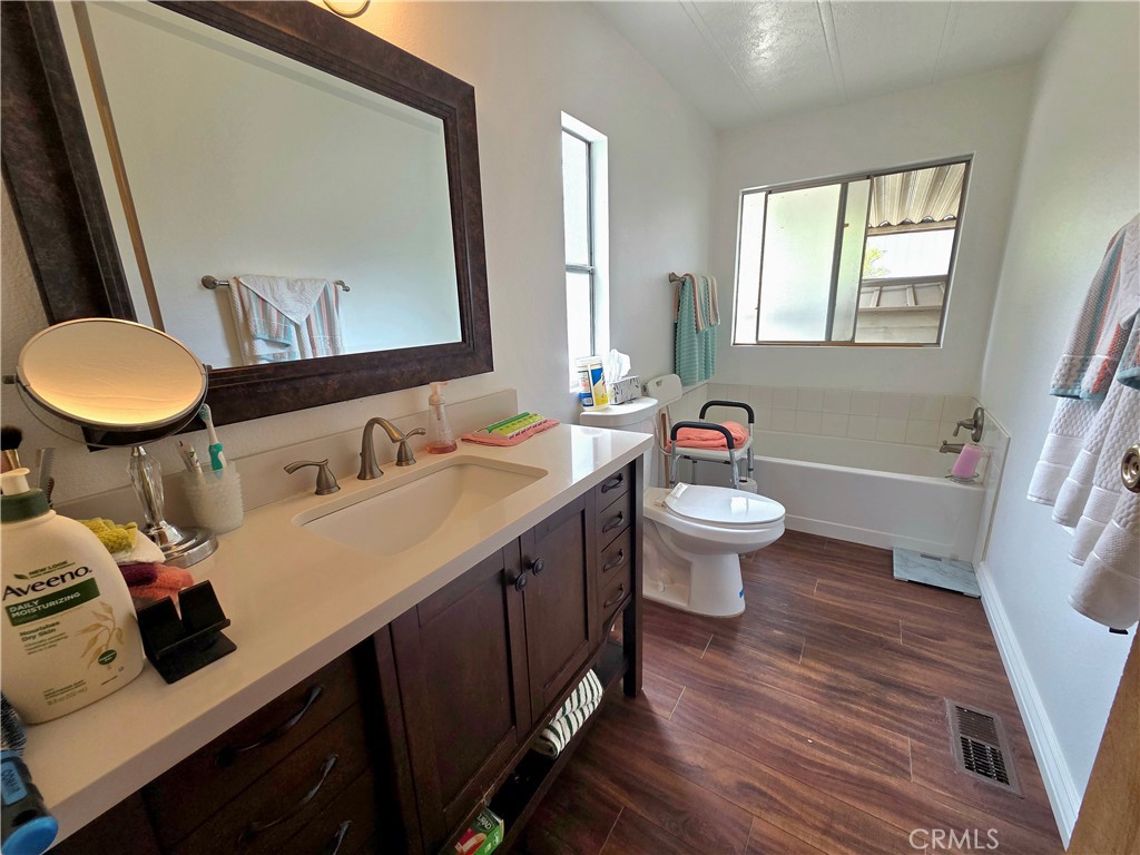 1550 Rimpau Avenue, Unit 20 Corona, CA 92881 - Photo 12 of 42 a bathroom with a sink double vanity granite and a toilet
