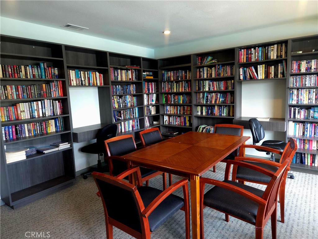 1550 Rimpau Avenue, Unit 20 Corona, CA 92881 - Photo 32 of 42 a view of a workspace with furniture and a bookshelf