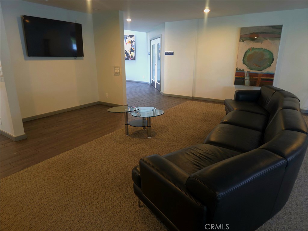 1550 Rimpau Avenue, Unit 20 Corona, CA 92881 - Photo 34 of 42 a living room with furniture and a flat screen tv