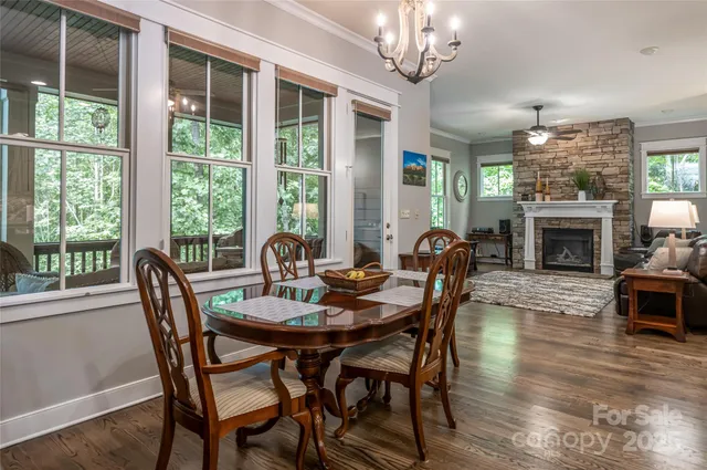 a dining room with furniture a fireplace and wooden floor