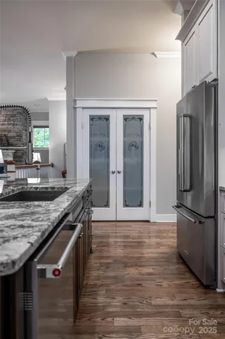 a kitchen with stainless steel appliances granite countertop a refrigerator and a stove