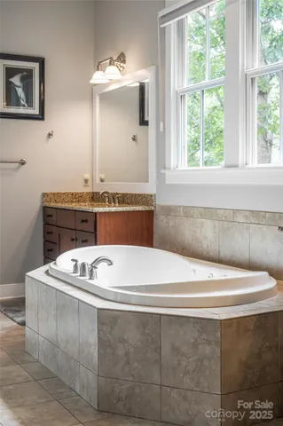 a bathroom with a sink mirror and window