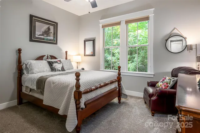 a bed sitting in a bedroom next to a window