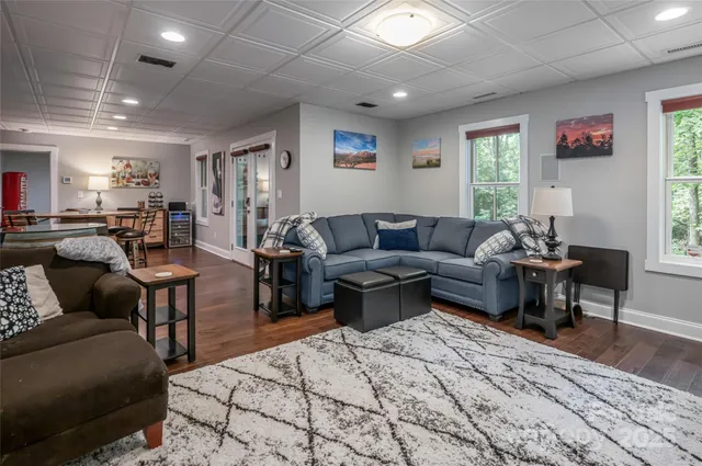 a living room with furniture a rug and a window