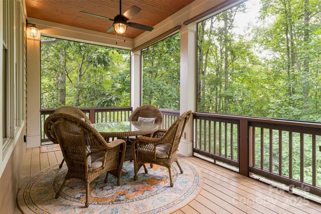a view of a balcony with chairs and wooden floor