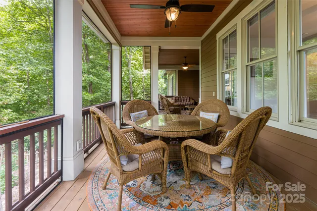 a view of a brick house with large windows and flower plants
