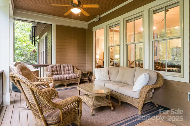 a living room with furniture and large windows