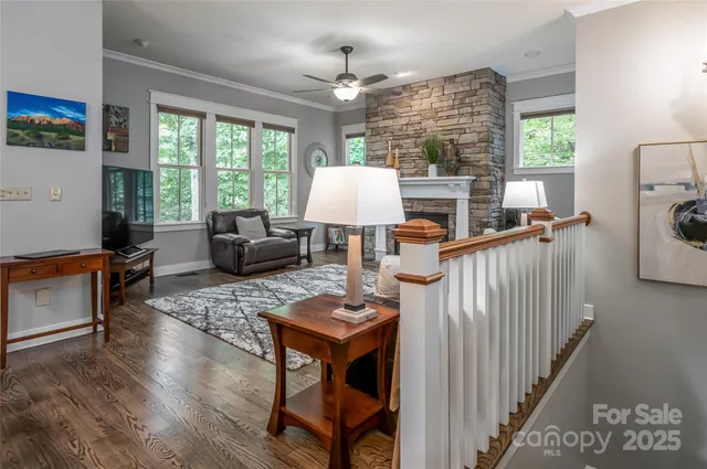 a living room with furniture a fireplace and a large window