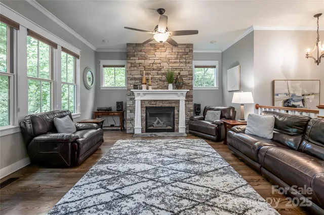 a living room with furniture a large window and a fireplace