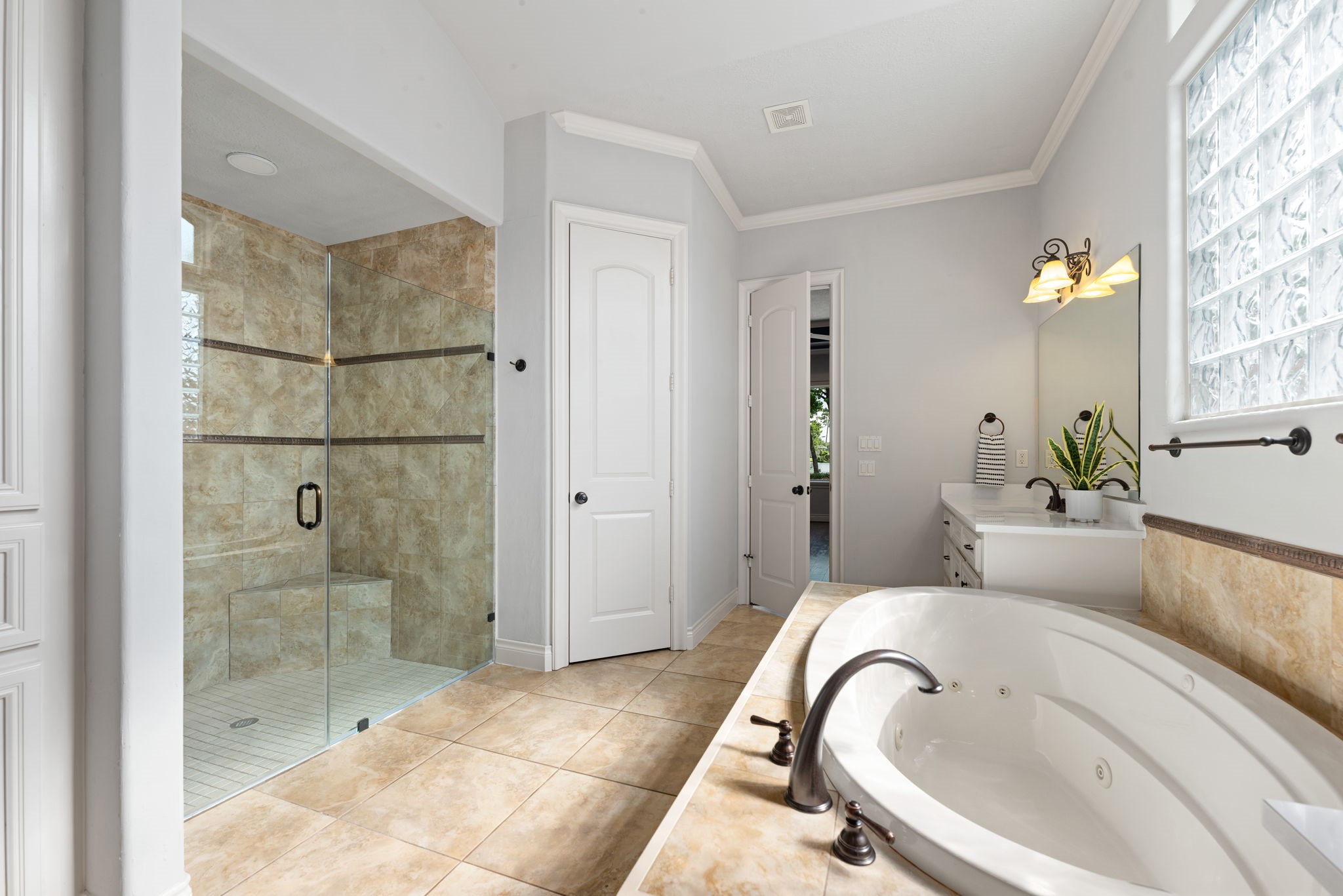 6006 Valhalla Drive Spring, TX 77379 - Photo 15 of 44 Luxurious primary bath with soaking tub, separate shower, and abundant natural light.