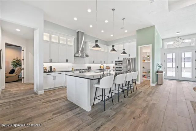 a living room with furniture a window and a flat screen tv