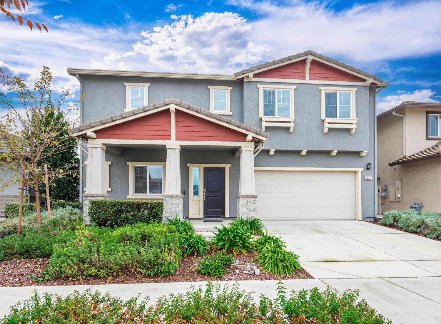 a front view of a house with yard and porch