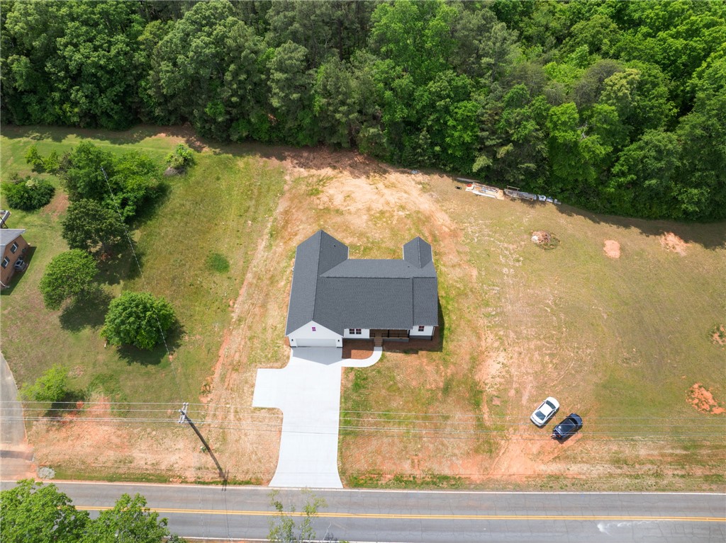 1735 Maw Bridge Road Central, SC 29630 - Photo 36 of 38 An aerial view showcases a newly constructed residence nestled amidst expansive green surroundings.
