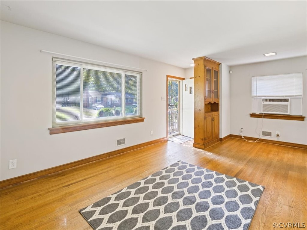 906 Pierpont Road Richmond, VA 23225 - Photo 5 of 24 a view of an empty room with a window and wooden floor