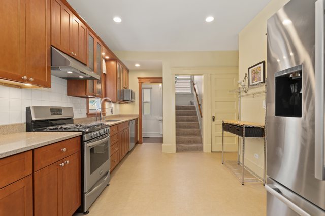 7009 34th Street Berwyn, IL 60402 - Photo 11 of 30 a kitchen with stainless steel appliances granite countertop a refrigerator and a stove top oven
