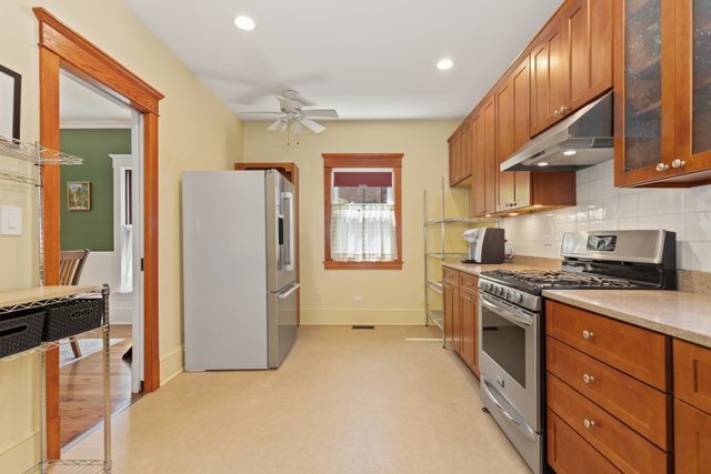 7009 34th Street Berwyn, IL 60402 - Photo 12 of 30 a kitchen with stainless steel appliances granite countertop a stove a refrigerator and a sink