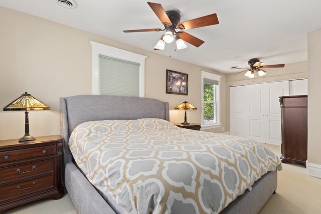 7009 34th Street Berwyn, IL 60402 - Photo 17 of 30 a bedroom with a bed and a chandelier