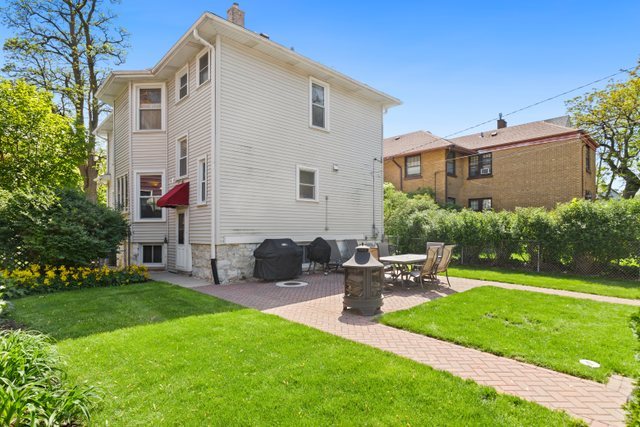 7009 34th Street Berwyn, IL 60402 - Photo 23 of 30 a front view of house with yard and outdoor seating