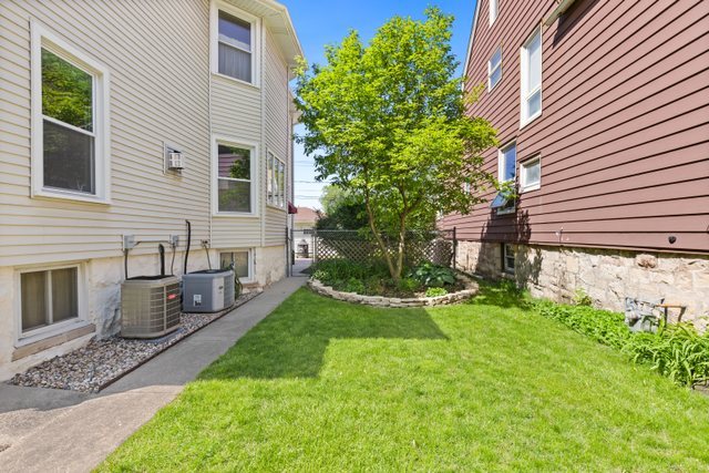 7009 34th Street Berwyn, IL 60402 - Photo 28 of 30 a backyard of a house with table and chairs and potted plants