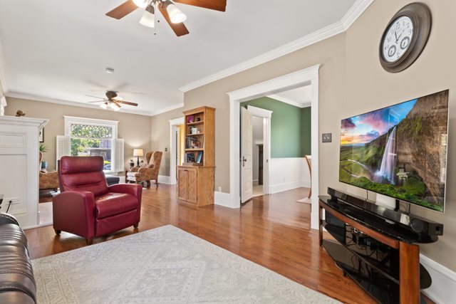 7009 34th Street Berwyn, IL 60402 - Photo 7 of 30 a living room with furniture a flat screen tv and a large window