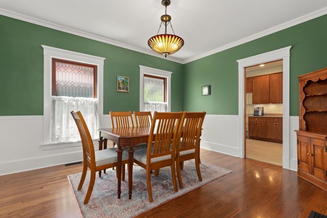 7009 34th Street Berwyn, IL 60402 - Photo 10 of 30 a dining room with furniture a chandelier and wooden floor