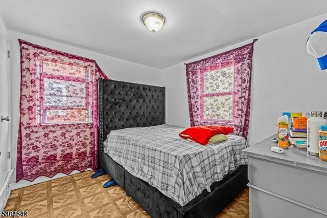 a bedroom with a bed and dresser with bathroom