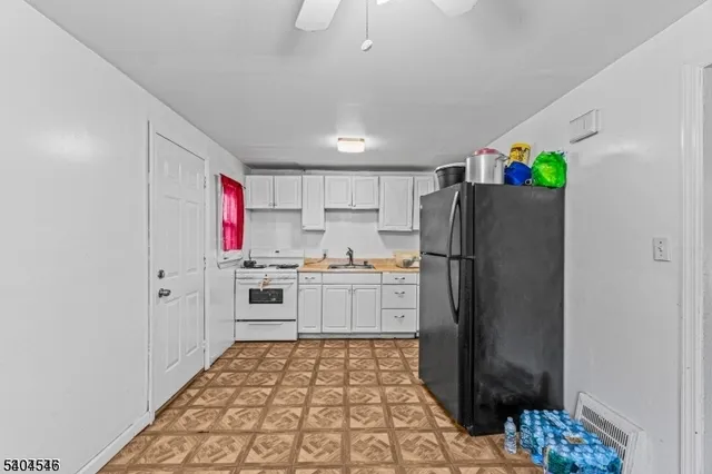 a kitchen with a refrigerator and a sink