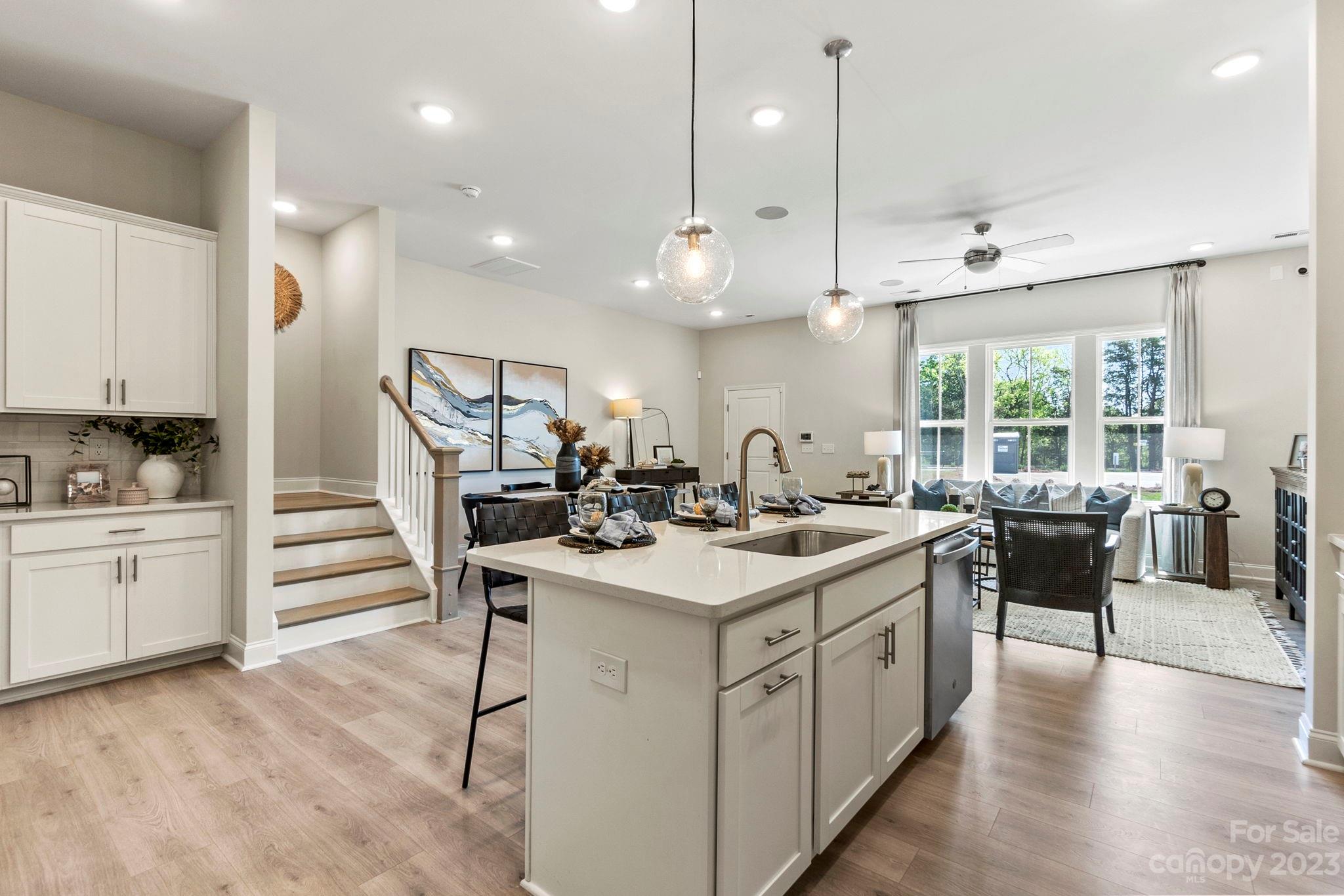 a kitchen with a sink stove and cabinets