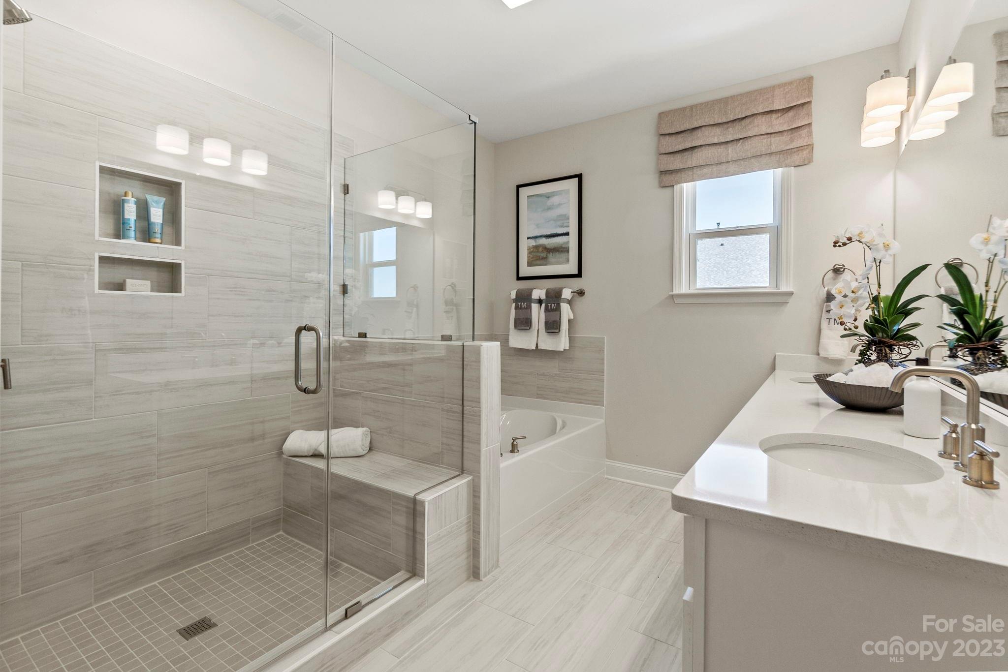 8915 Winding Waters Road Harrisburg, NC 28215 - Photo 21 of 30 a bathroom with a sink a toilet and shower