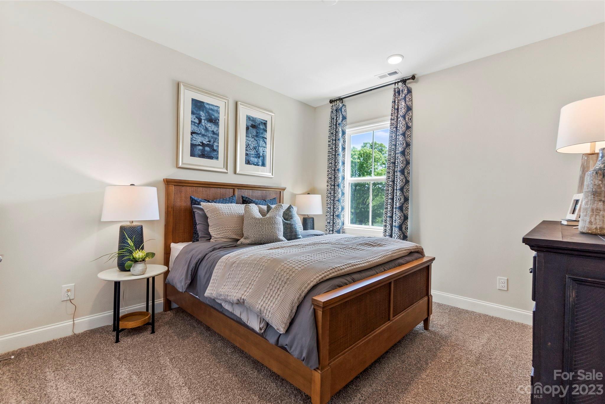 8915 Winding Waters Road Harrisburg, NC 28215 - Photo 24 of 30 a bed sitting in a bedroom next to a window