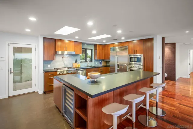 a kitchen with a table chairs and a refrigerator