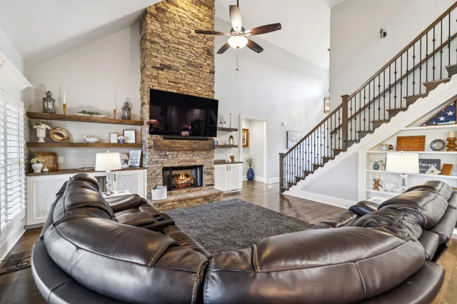a kitchen with stainless steel appliances granite countertop a refrigerator and a white cabinets