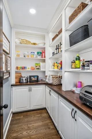 a bathroom with a granite countertop double vanity sink and mirror
