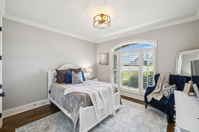 a living room with furniture a fireplace and a floor to ceiling window