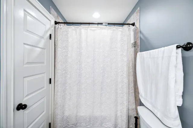 an aerial view of a house with swimming pool garden and lake view