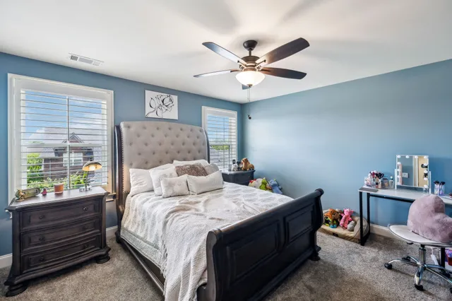 an aerial view of a residential houses with outdoor space and street view