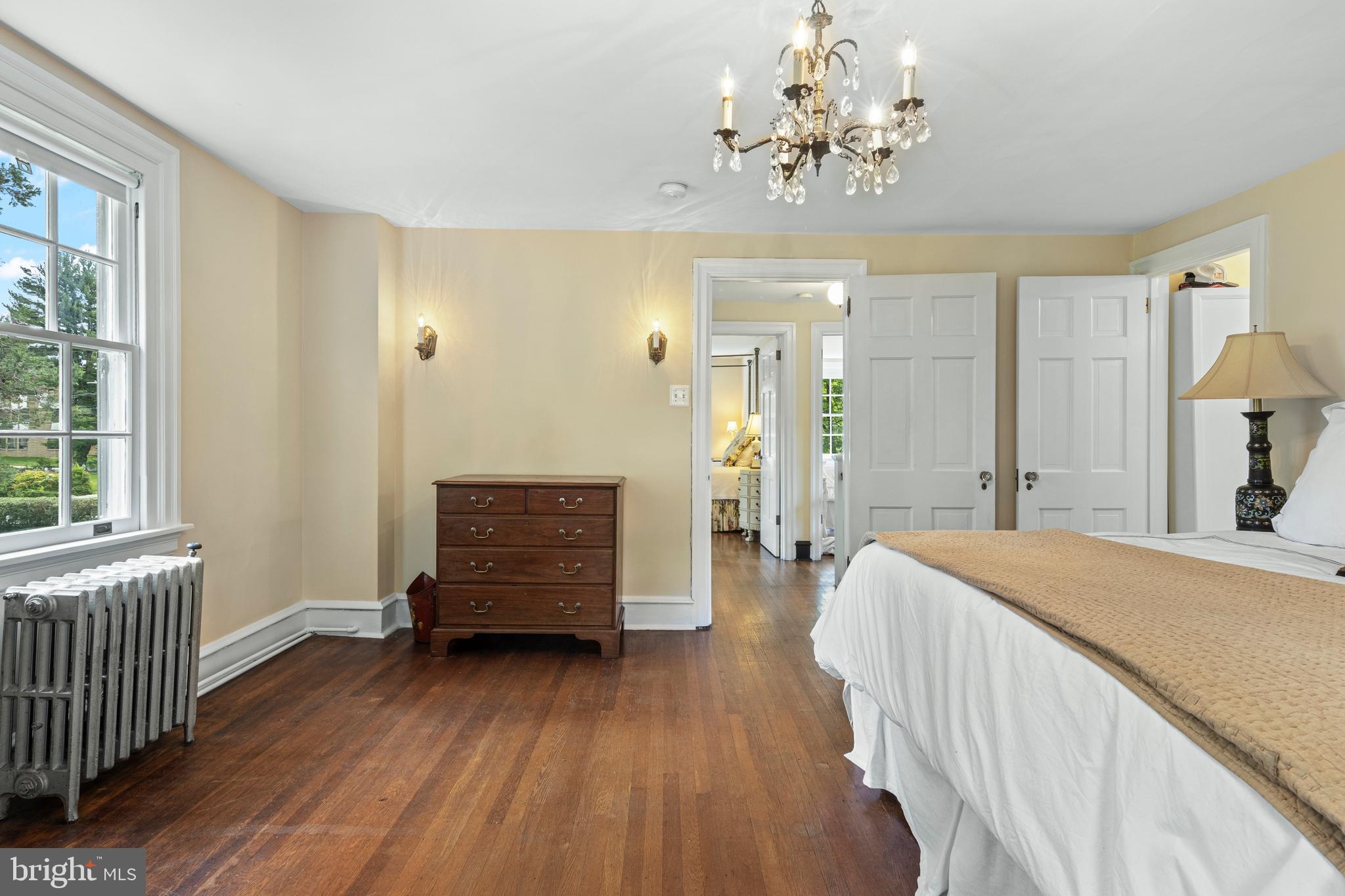 60 Old Eagle School Road Wayne, PA 19087 - Photo 19 of 43 a bedroom with a bed and a chandelier