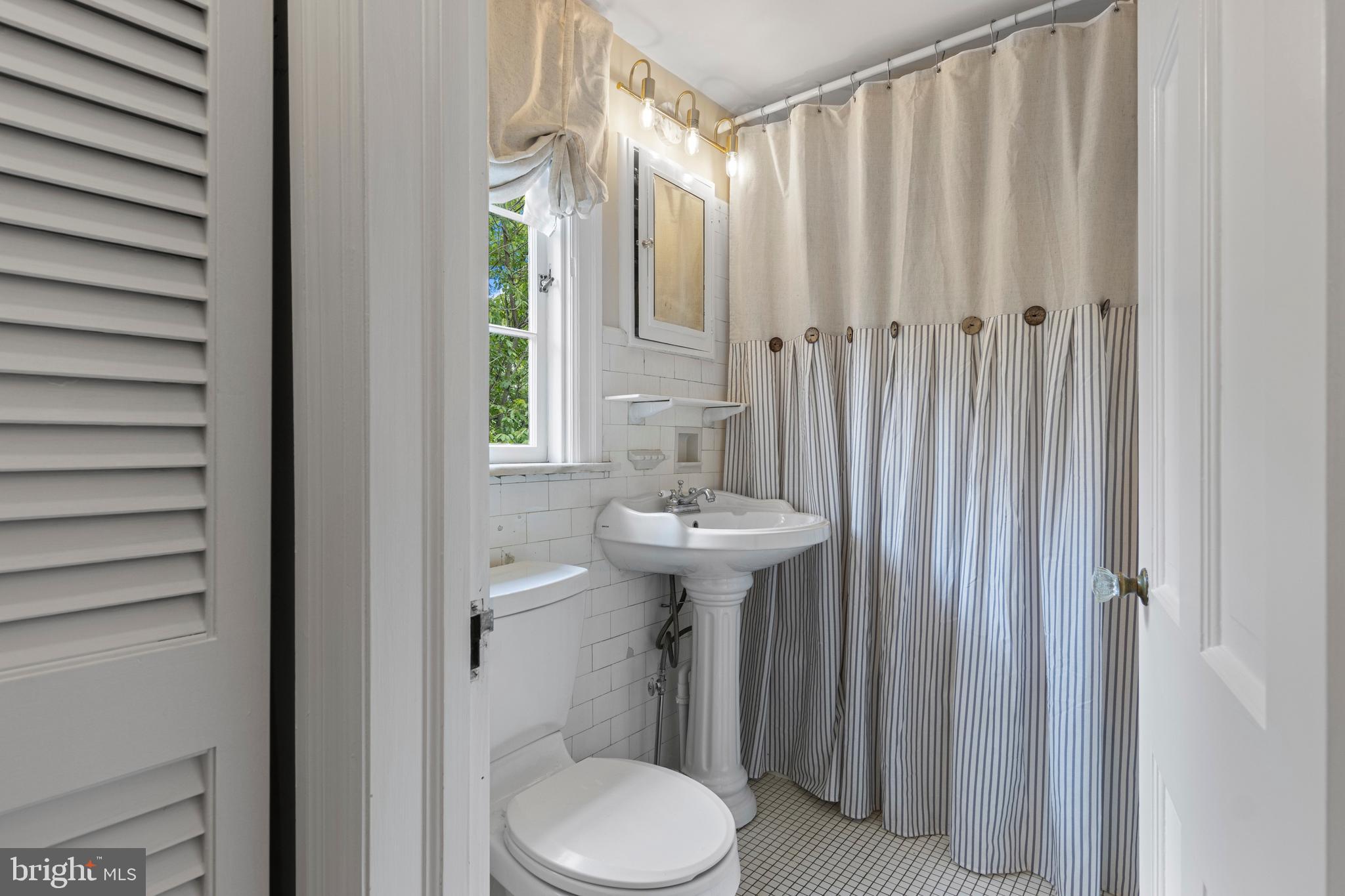 60 Old Eagle School Road Wayne, PA 19087 - Photo 20 of 43 a bathroom with a sink a toilet and shower