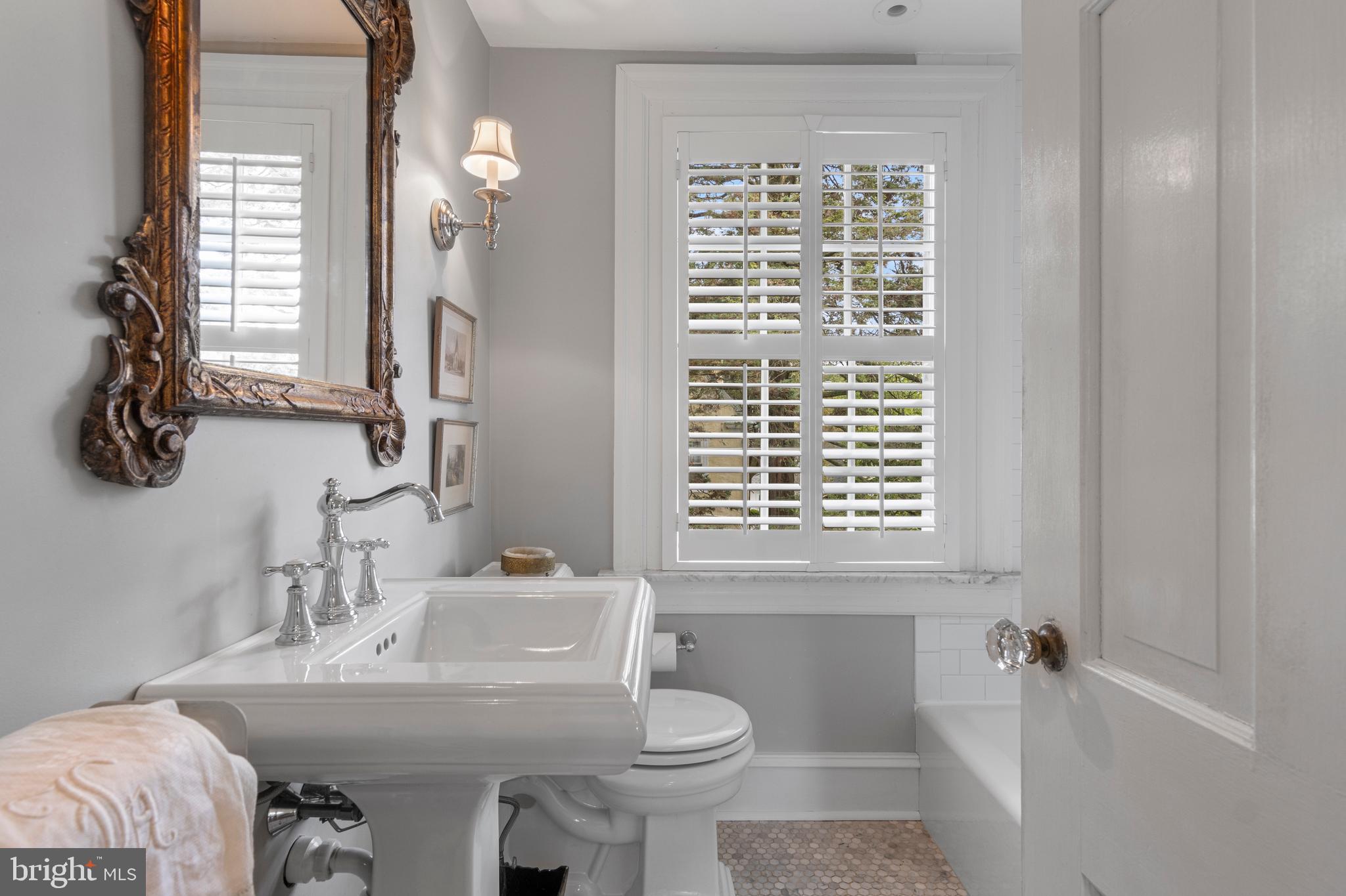 60 Old Eagle School Road Wayne, PA 19087 - Photo 22 of 43 a bathroom with a sink a toilet and a mirror