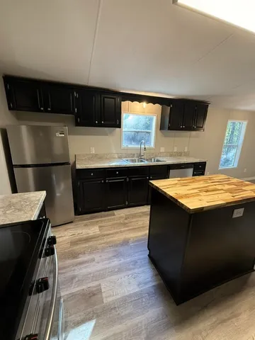 a kitchen with stainless steel appliances granite countertop a sink and a stove