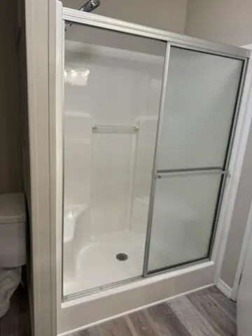 a bathroom with a glass shower door