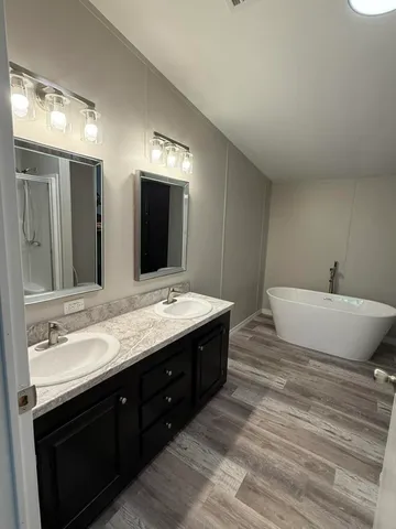 a spacious bathroom with a double vanity sink and a mirror