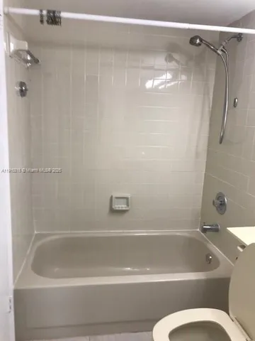 a view of an empty room with a bathroom