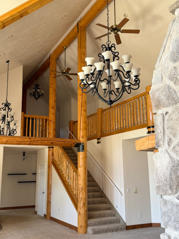 4458 East Glencoe Road Preston, ID 83263 - Photo 6 of 46 Vaulted ceiling with exposed wood beams, carpeted flooring, and a stone-clad fireplace
