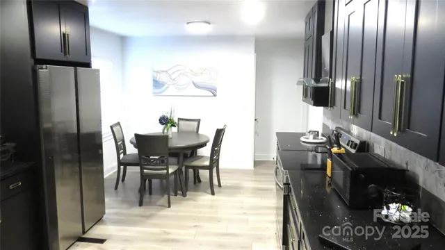 a dining room with furniture and a chandelier