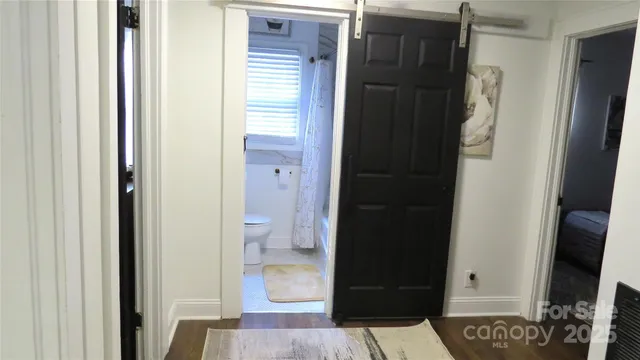 a bed sitting in a bedroom next to a window