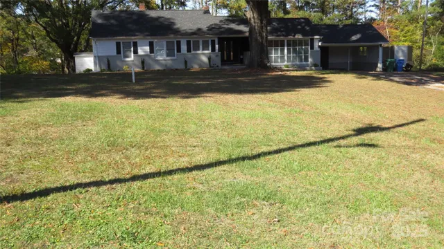 a view of swimming pool with a lawn chairs under an umbrella
