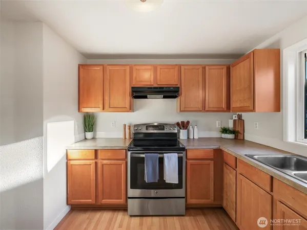 a kitchen with a stove a sink and a microwave